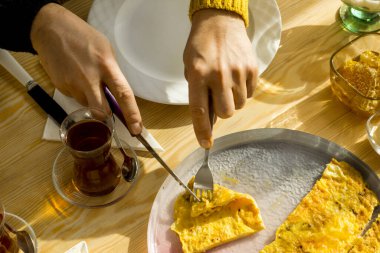 Elleri çırpılmış yumurta, evde günlük kahvaltı, gün ışığıyla birlikte ahşap masada..
