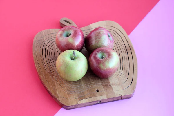 Four,fresh apples on the apple shaped wood at double vivid color surface,Harvest.