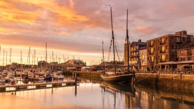 Sunrise at a History Harbour, Plymouth Barbican. clipart