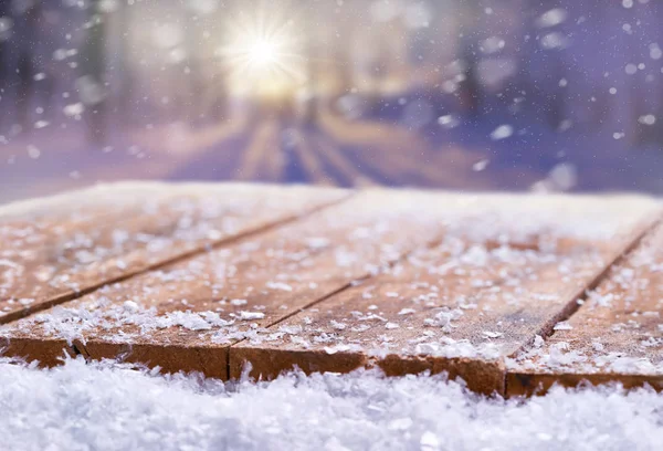 Wooden table top covered in snow with a Christmass, winter and s — Stock Photo, Image