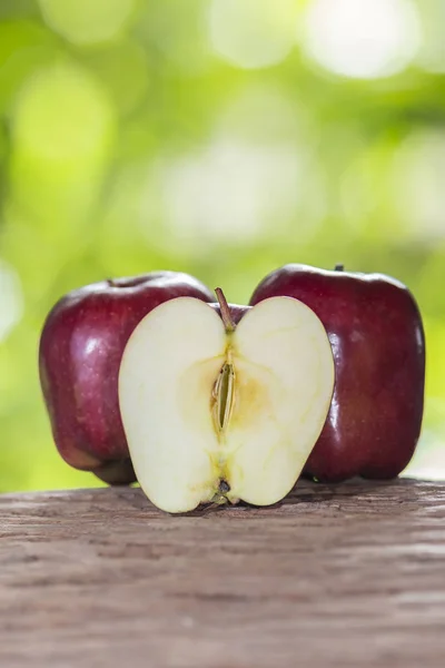 Apple on a wooden floor and has a background of nature — Stock Photo, Image