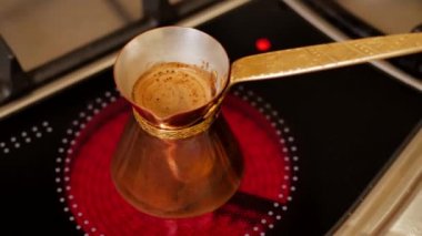Brewed coffee is in pots on the stove