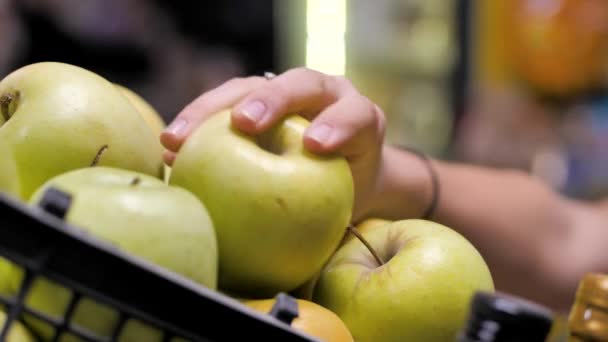 El cliente lleva manzanas verdes a la cesta desde el mostrador — Vídeos de Stock