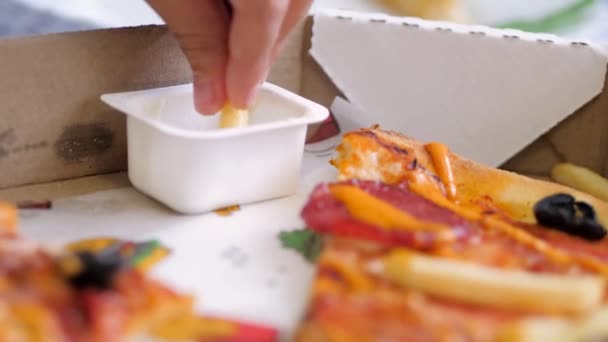 Pizzabezorging. kinderen dompelen de frietjes in witte saus — Stockvideo