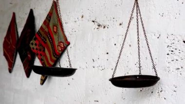 Textiles hanging on the walls. the scales are suspended from the ceiling