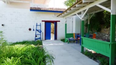 In the patio in Eastern style. green trestle beds with pillows, white walls