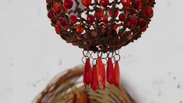 The chandelier is decorated with beads of different sizes, red — Stockvideo