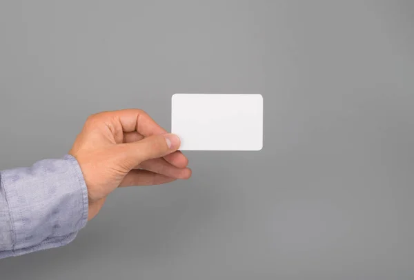 Hand holds white business card — Stock Photo, Image