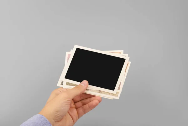 Hand holding stack of photos — Stock Photo, Image