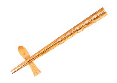 pair of wood chopsticks with wood holder isolated on a white bac