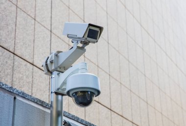 security camera on metal beam of modern office building 