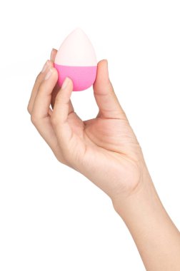 hand holding Pink egg beauty sponge isolated on a white backgrou