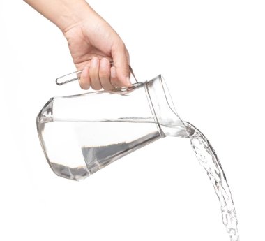 Hand pouring water from glass jug to glass isolated on a white b