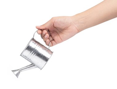 hand holding a small metal watering can with spout isolated on w