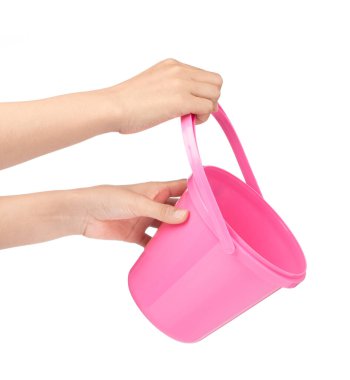 hand holding Pink plastic bucket for water isolated on white bac