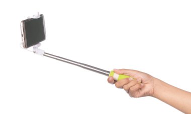 hand holding selfie stick with  mobile phone isolated on a white