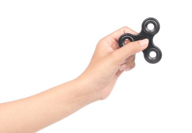 fingers playing a black fidget spinner isolated on a white backg