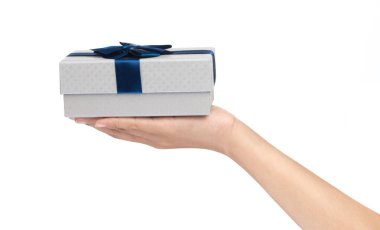 hand holding a Gift color silver box with blue ribbon and bow is