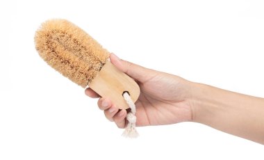 hand holding Wooden body bath brush isolated on white background