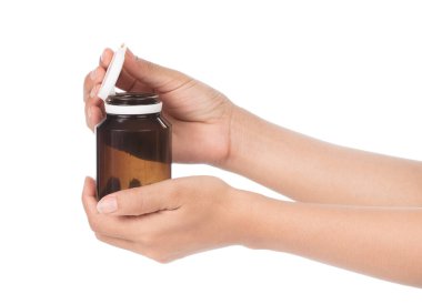 hand holding Brown Drug Bottle isolated on white background