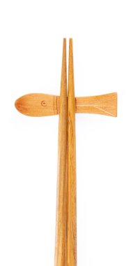 pair of wood chopsticks with wood holder isolated on a white bac