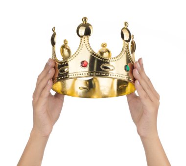 Hand holding Gold Crown with jewel isolated isolated on white ba