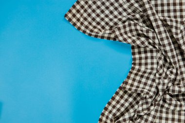 black checkered tablecloth on blue background