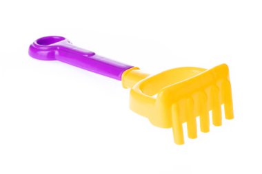 Rake of plastic toy isolated on a white background.