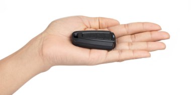 Hand holding a car keys centralized control isolated on white ba