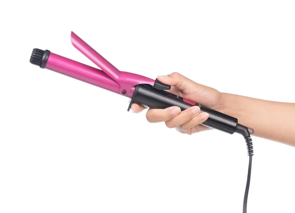 Hand holding purple curling iron isolated on white background — ストック写真