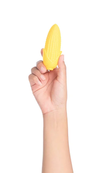 Hand holding plastic toy corn isolated on white background — Stock Photo, Image