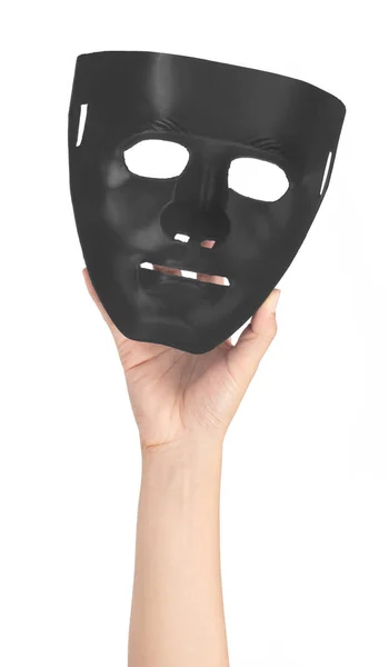 Mão segurando máscaras pretas isoladas no fundo branco — Fotografia de Stock