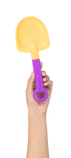 Hand holding plastic tool shovel of beach toy isolated on white — 스톡 사진