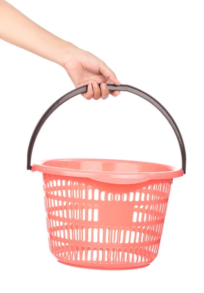 Hand holding a red laundry basket isolated on white background — 图库照片