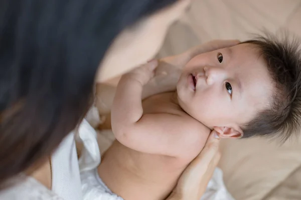 Mother staring at her cute little baby. — Stock Photo, Image