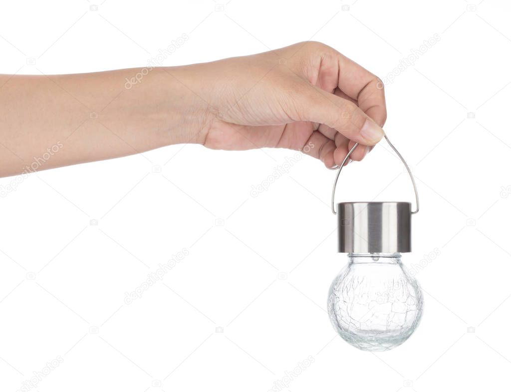 Hand holding glass ball lamp isolated on white background
