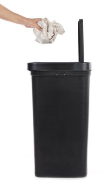 hand throwing paper in modern garbage can isolatedon white backg