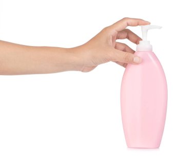 hands pumping out cream from bottle isolated on white background