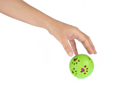 Hand holding Green ball toy for pet isolated on white background