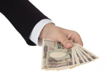 Businesswoman giving money and holding 10,000 japanese yen money