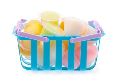 basket of Jelly in plastic containers isolated on white backgrou