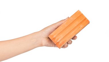 hand holding red brick isolated on white background