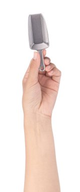 hand holding silver scoop isolated on white background
