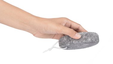 hand holding pumice stone for scrubbed and body care isolated on