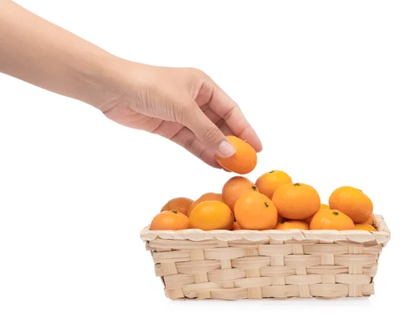 Hand holding orange in bamboo basket isolated on white backgroun — Stock Photo, Image