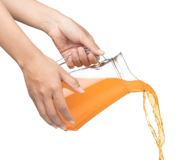 Hand pouring Peach fruit juice isolated on a white background — Stok fotoğraf