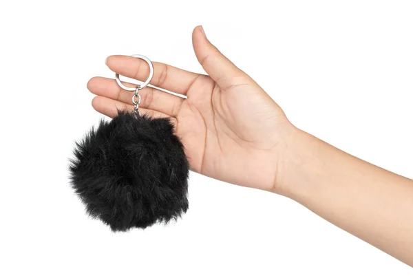 Hand holding key chain of a pink fur ball isolated on white back — Stockfoto