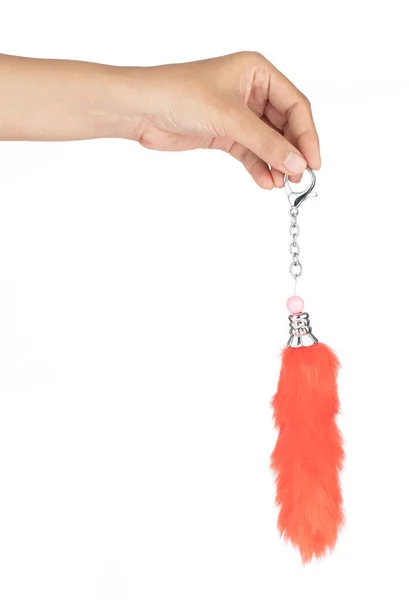 Hand holding Orange keychains fox tail fur isolated on white bac — Stockfoto