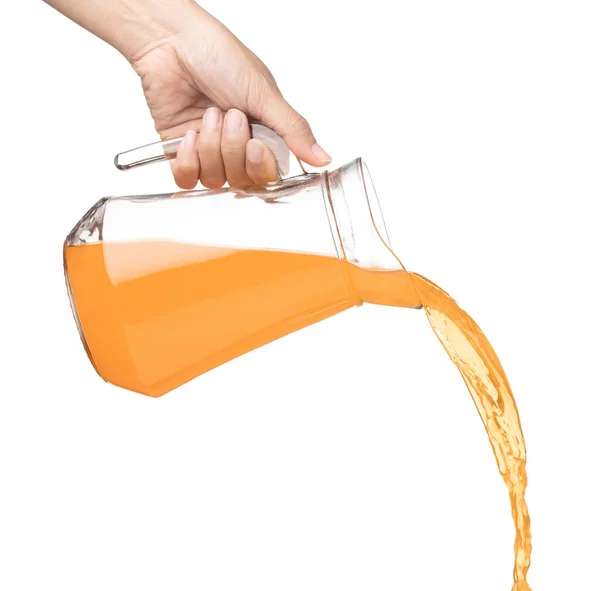 Hand pouring Peach fruit juice isolated on a white background — Stock Photo, Image