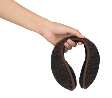 Hand holding A Brown winter knitted earmuffs isolated on white b